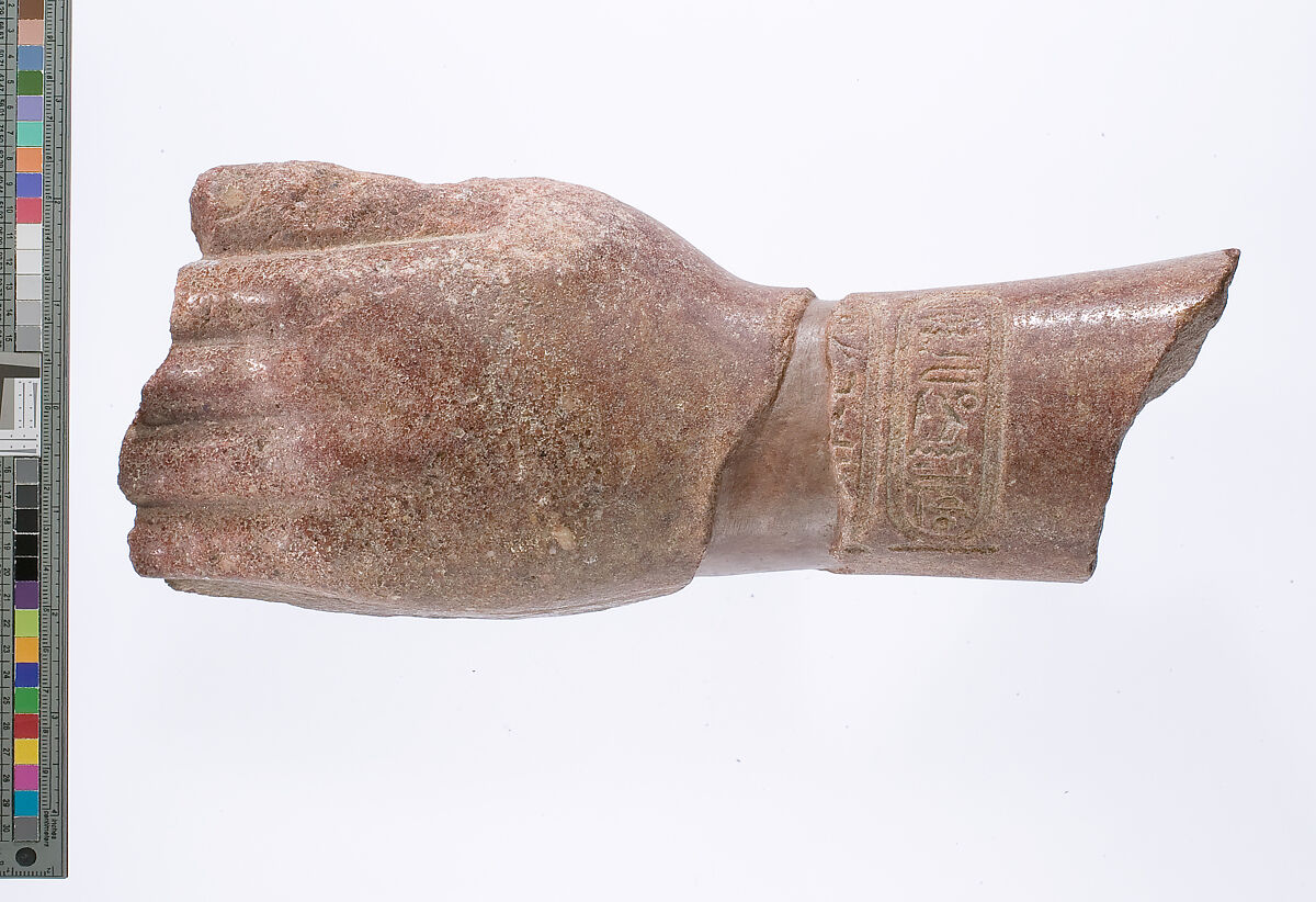 left hand and arm fragment with Aten cartouches from a statue supporting a stela?, Red quartzite