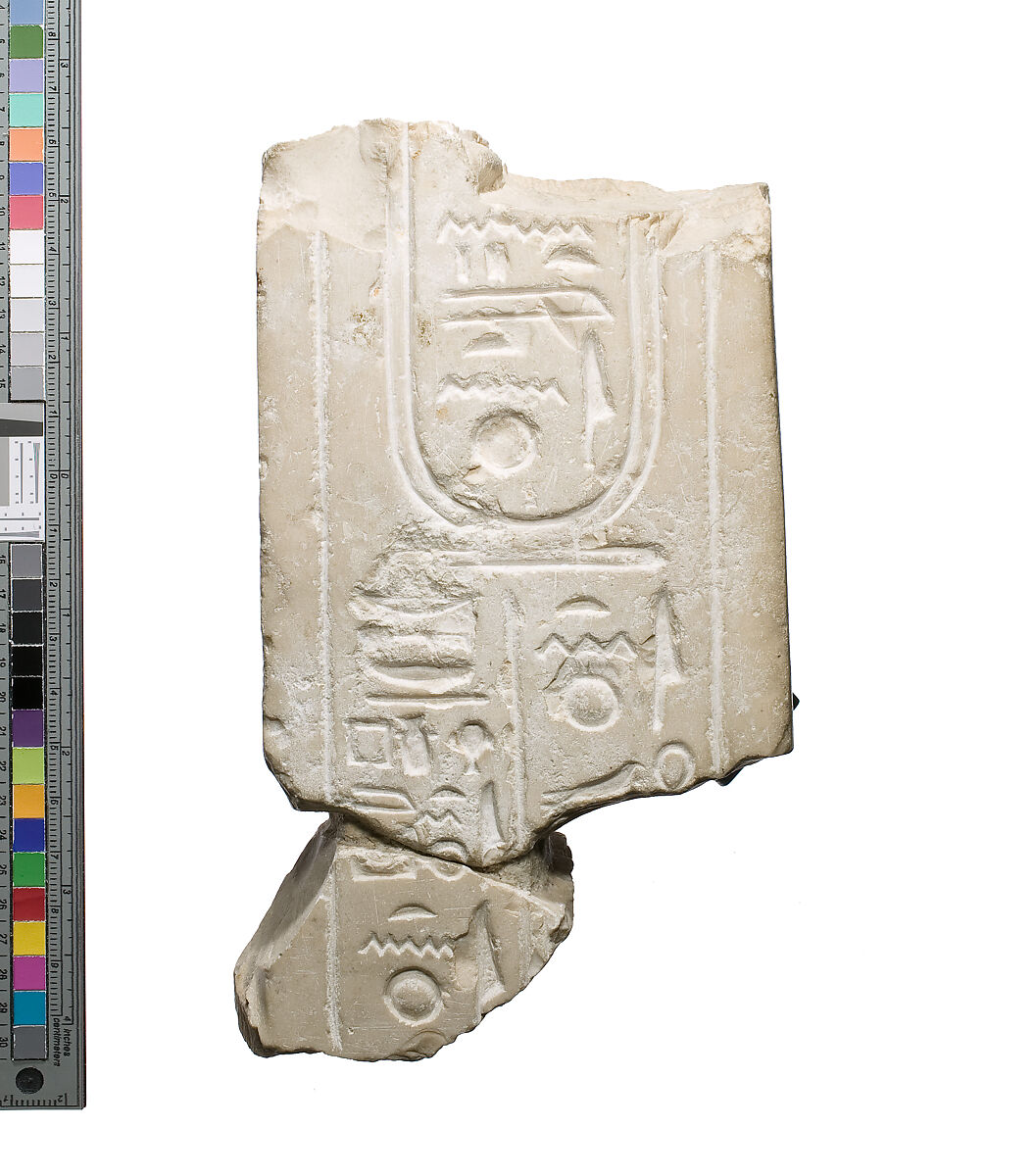 Inscribed pillar and support area against body, Indurated limestone