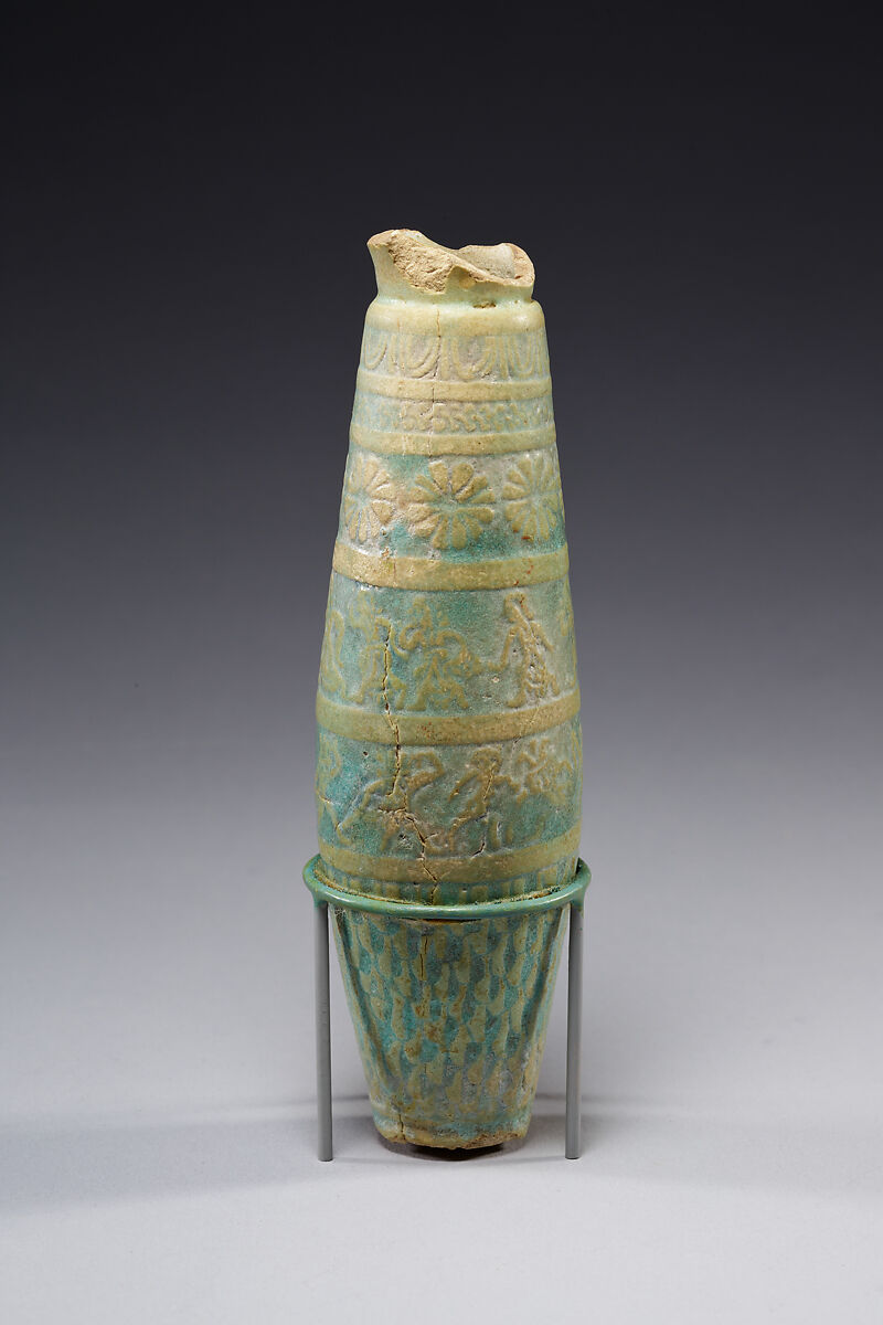 Biconical alabastron with zones of bichrome decoration including floral elements, dancers, and Bes-like figures, Faience