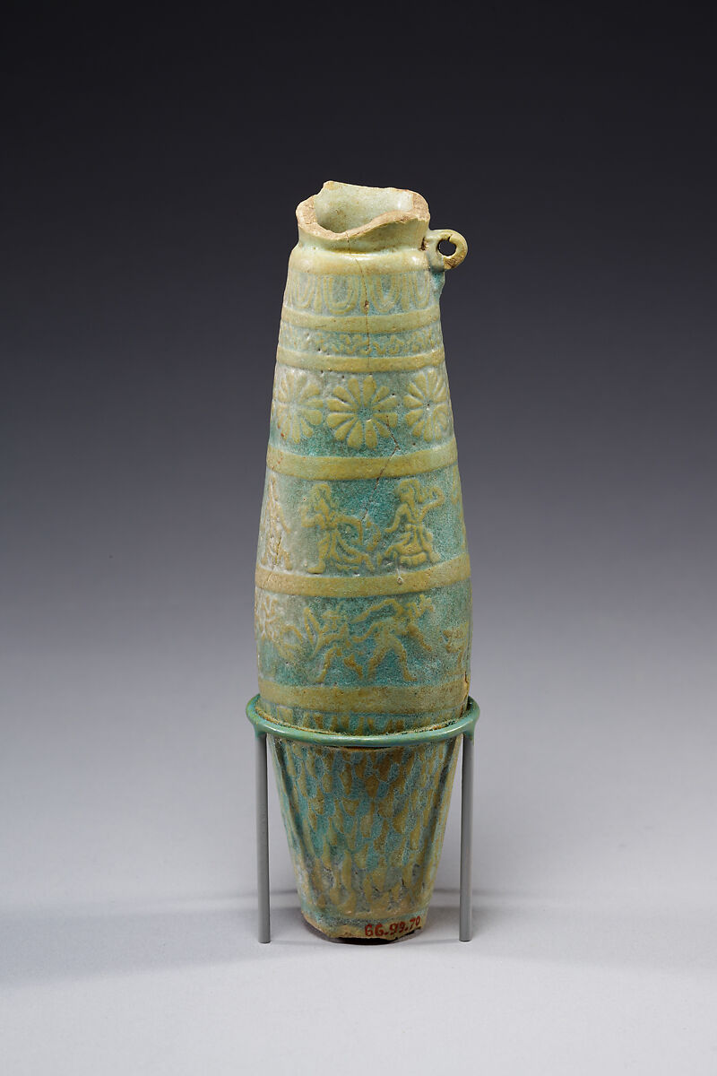 Biconical alabastron with zones of bichrome decoration including floral elements, dancers, and Bes-like figures, Faience