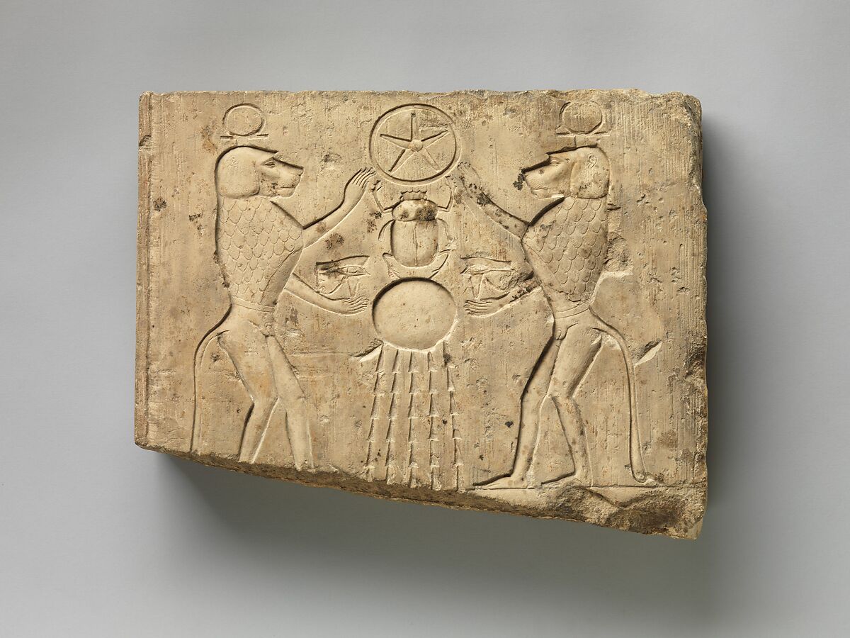 Relief panel showing two baboons offering the wedjat eye to the sun god Khepri, who holds the Underworld sign, Limestone 
