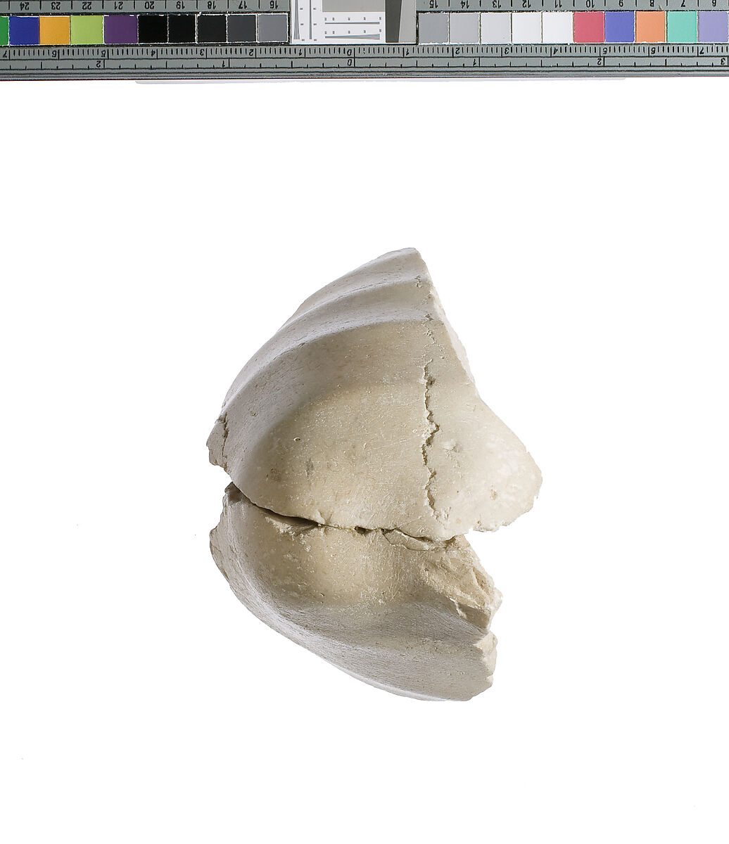 Elbow, with garment, Indurated limestone