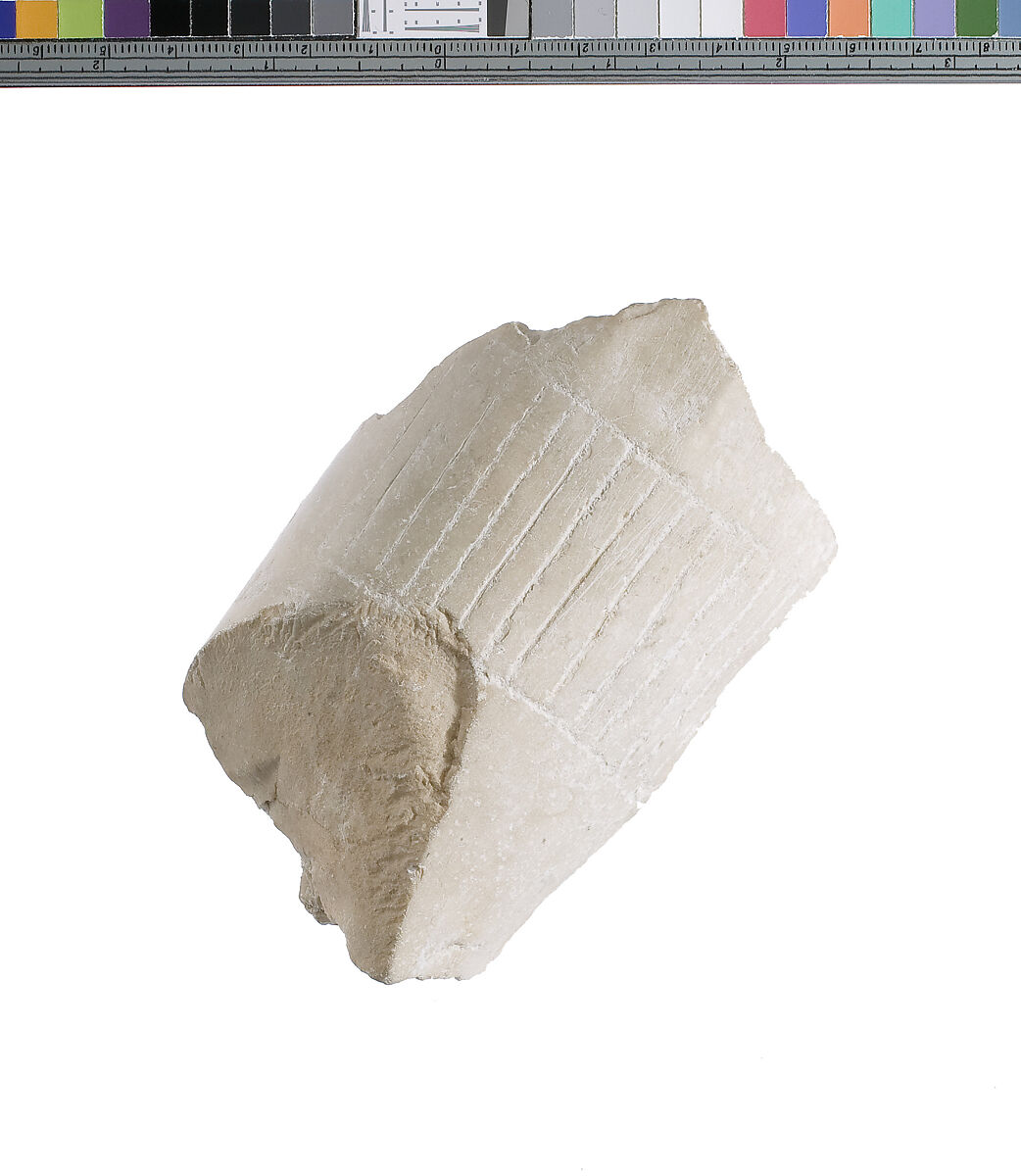 Pleated garment with selvage at ankle, Indurated limestone