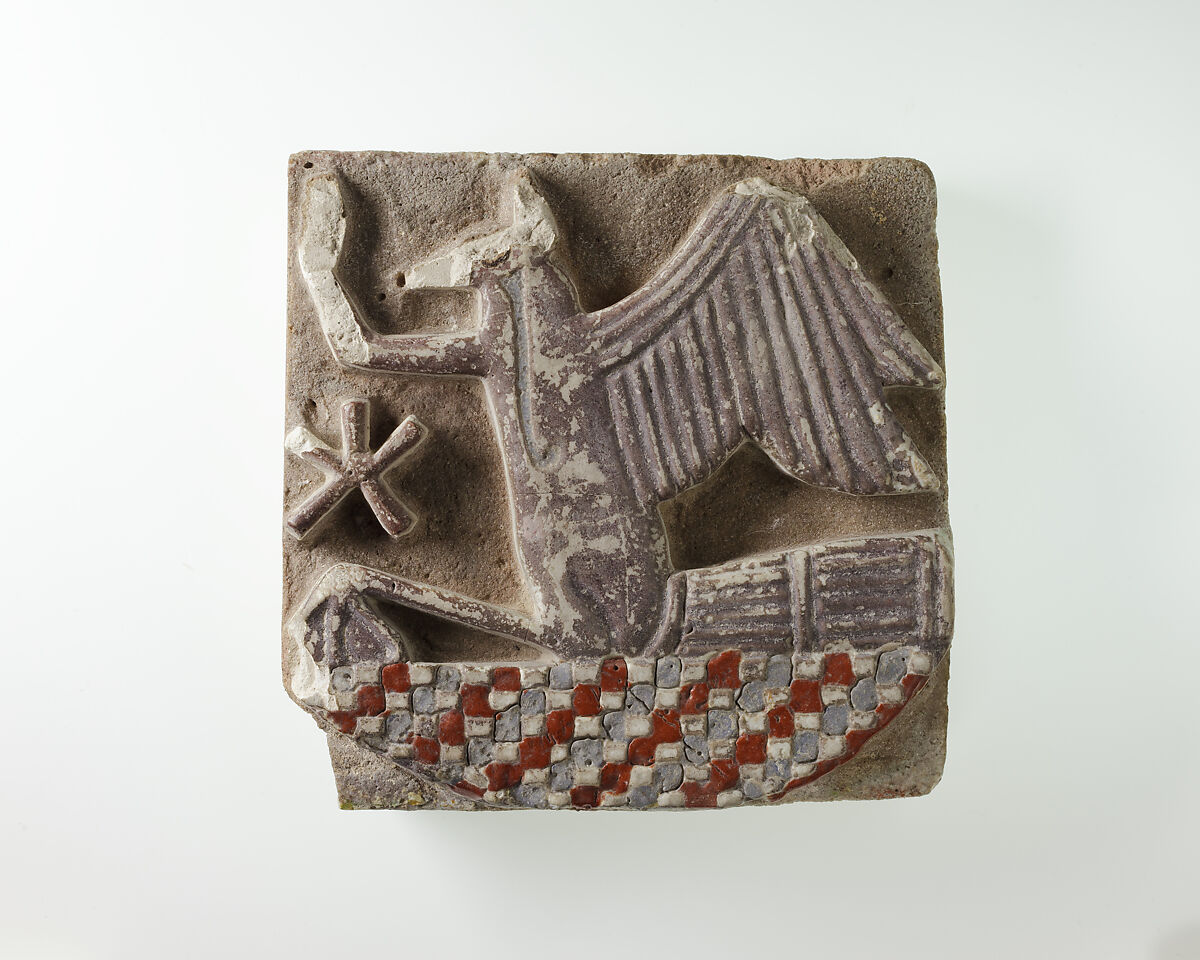 Tile in the form of a rekhyt bird surmounting a neb sign, Faience 