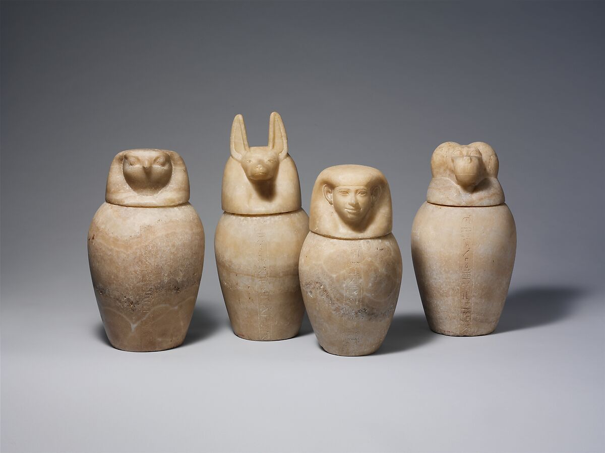 Canopic jar with a jackal-headed lid, Travertine (Egyptian alabaster)