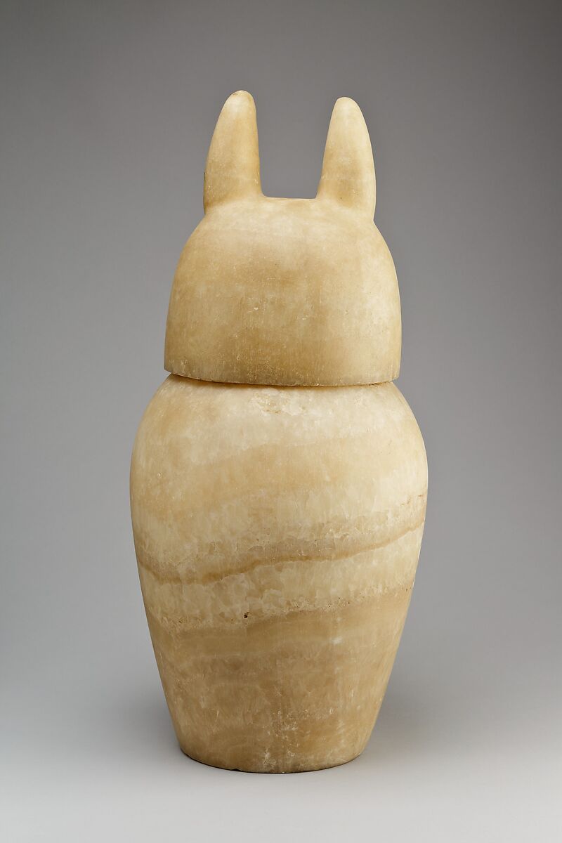 Canopic jar with a jackal-headed lid, Travertine (Egyptian alabaster)