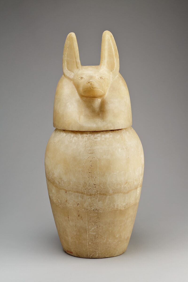 Canopic jar with a jackal-headed lid, Travertine (Egyptian alabaster) 