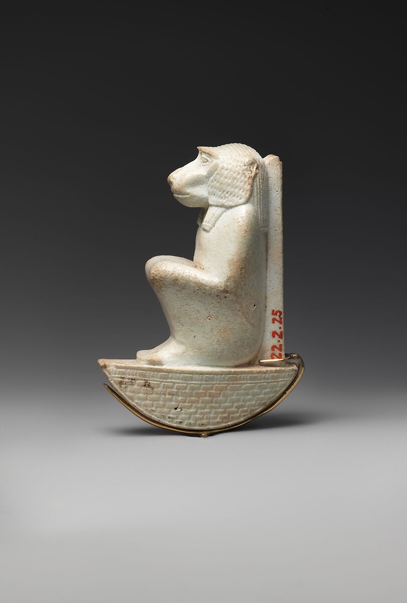 Figure of baboon on a basket and with a pillar, the shebet offering, Faience