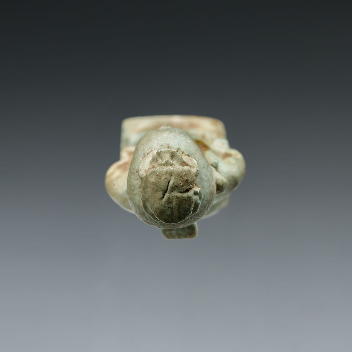 Amulet: Pataikos astride crocodiles and with a scarab on his head, Faience
