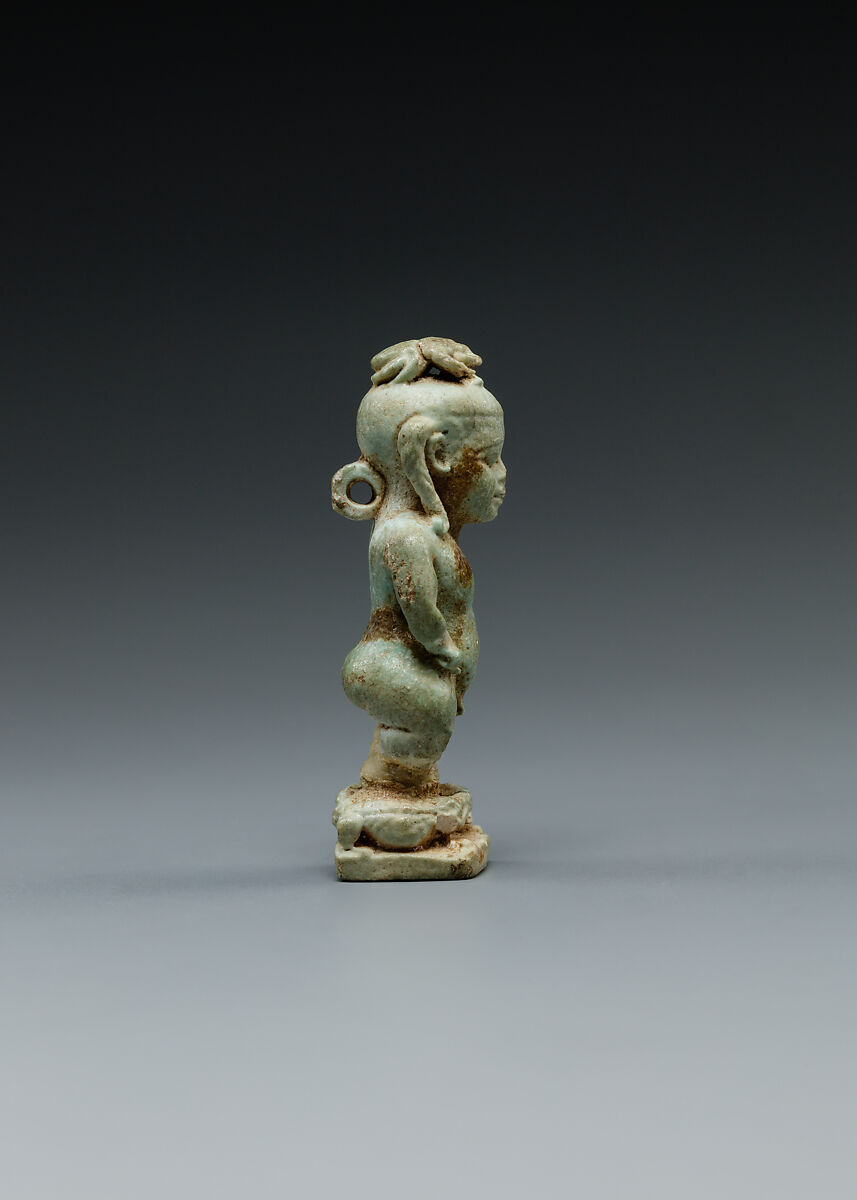 Amulet: Pataikos astride crocodiles and with a scarab on his head, Faience