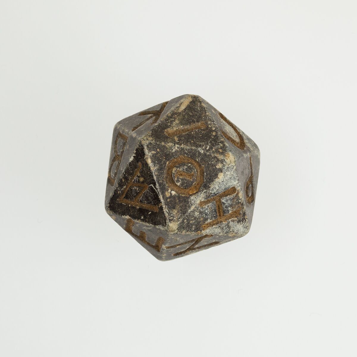 Twenty-sided die (icosahedron) with faces inscribed with Greek letters, Serpentinite 