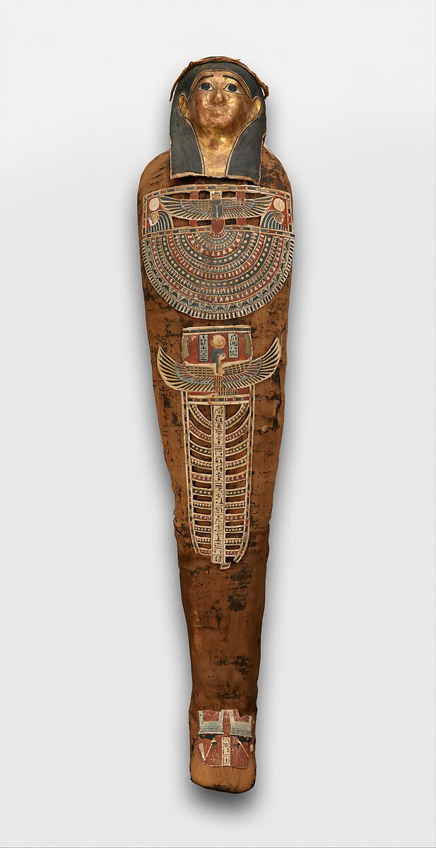 Mummy of Nesmin with plant wreath, mask, and other cartonnage elements, Mummified human body, linen, mummification material, faience? (amulets), painted and gilded cartonnage, plant remains 