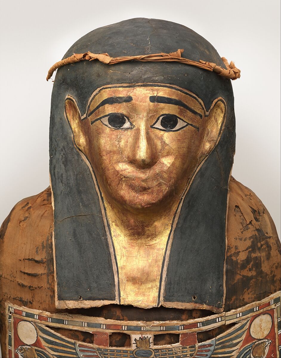 Mummy of Nesmin with plant wreath, mask, and other cartonnage elements, Mummified human body, linen, mummification material, faience? (amulets), painted and gilded cartonnage, plant remains
