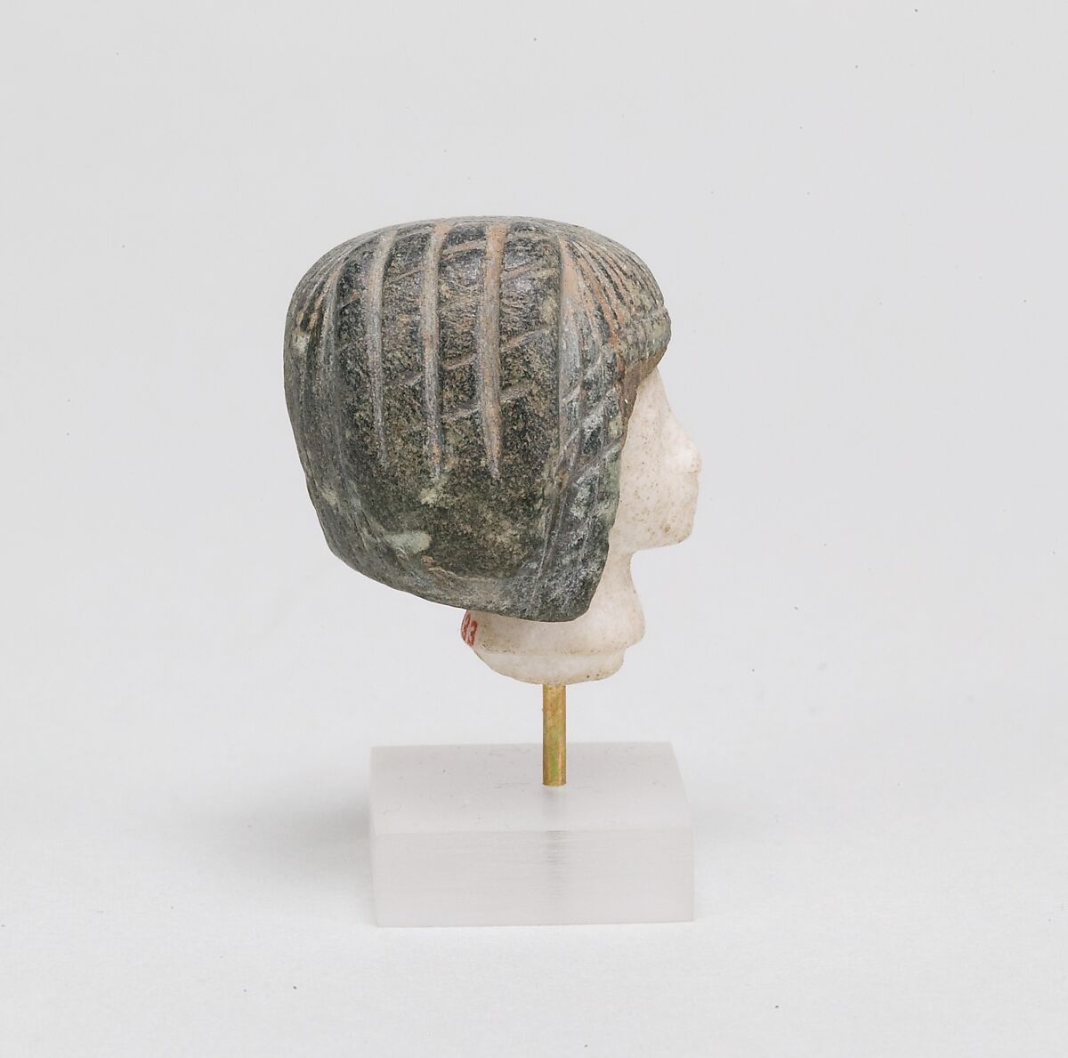 Head from a Spoon in the form of a Swimming Girl, Travertine (Egyptian alabaster), steatite