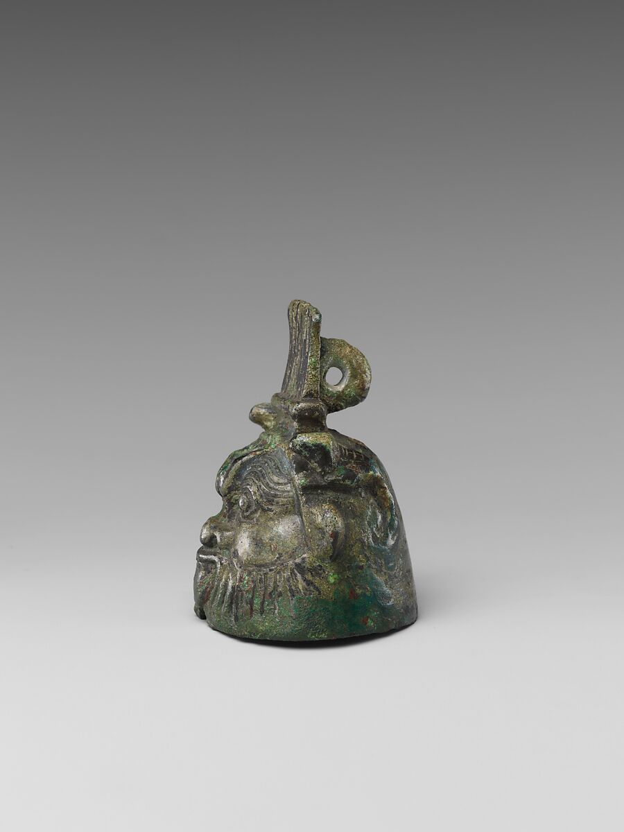 Bell in the form of Bes, cupreous metal