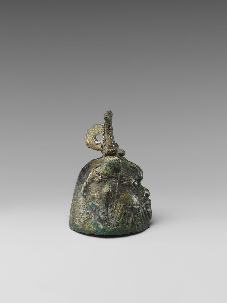 Bell in the form of Bes, cupreous metal