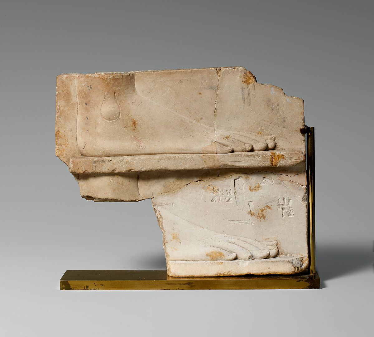 Sculptor's model / votive relief with two sides: side one, two registers with a right foot on each; side two, a royal-like figure, Limestone 