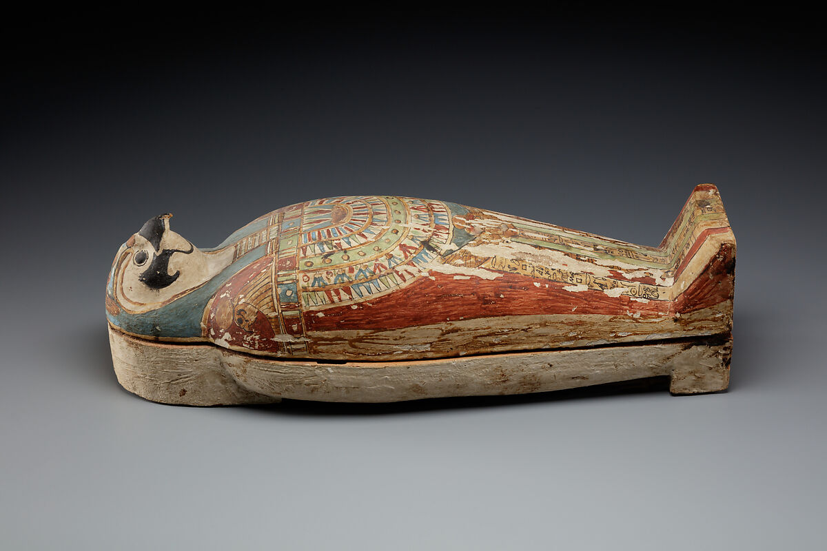 Falcon-form case containing a corn mummy, Painted gessoed wood; mummy: linen, resin, fiber