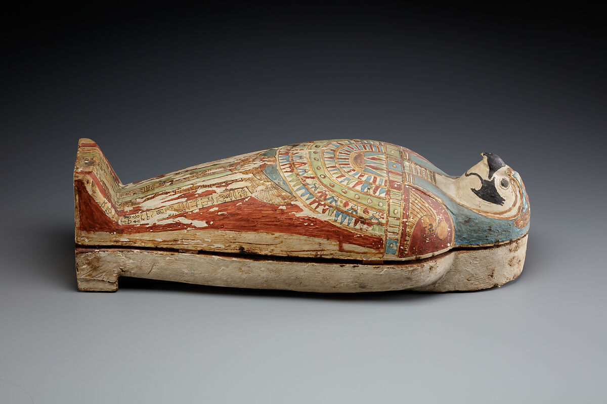 Falcon-form case containing a corn mummy, Painted gessoed wood; mummy: linen, resin, fiber