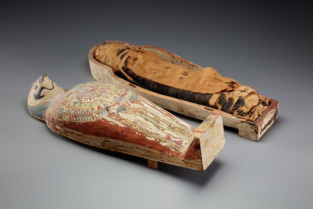 Falcon-form case containing a corn mummy, Painted gessoed wood; mummy: linen, resin, fiber