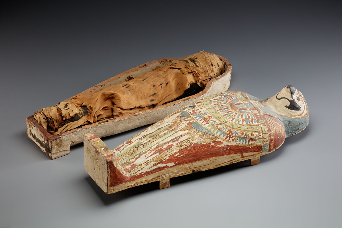 Falcon-form case containing a corn mummy, Painted gessoed wood; mummy: linen, resin, fiber