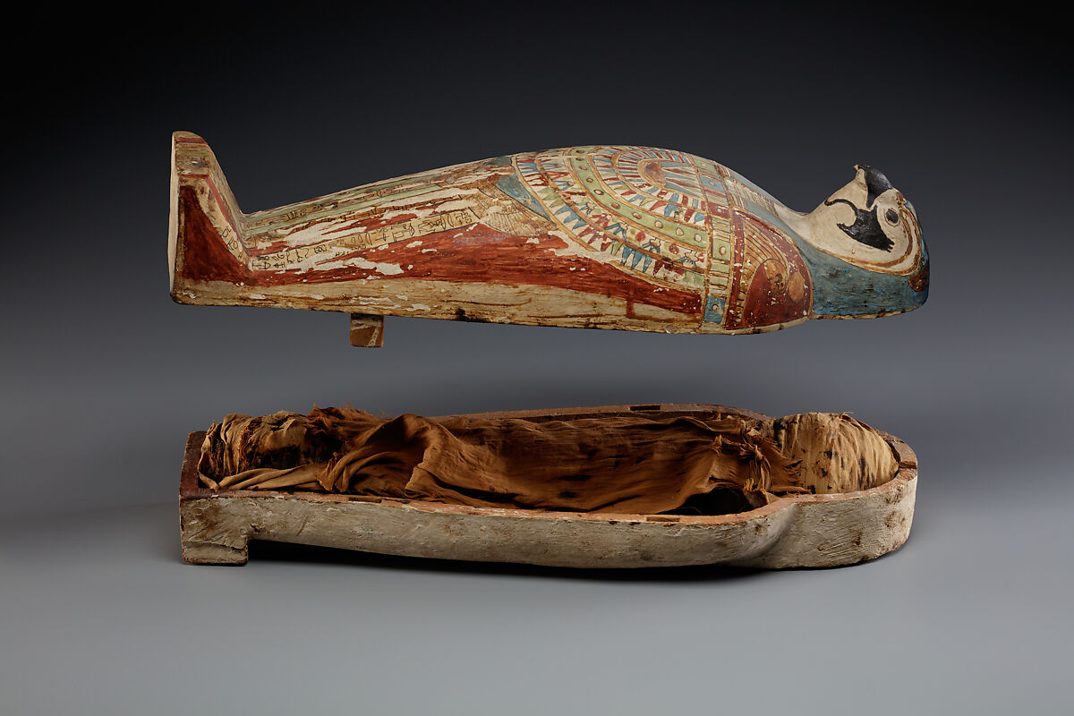 Falcon-form case containing a corn mummy, Painted gessoed wood; mummy: linen, resin, fiber