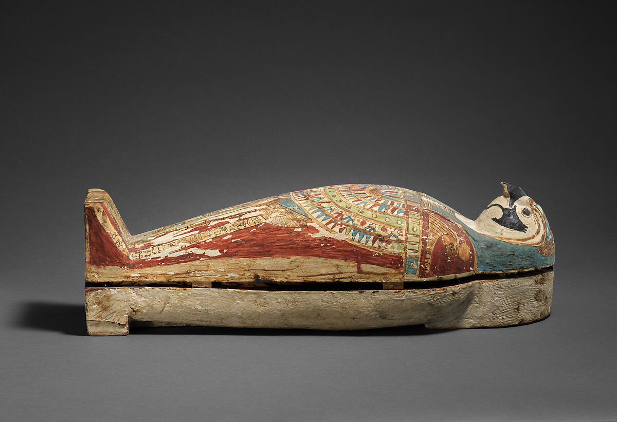 Falcon-form case containing a corn mummy, Painted gessoed wood; mummy: linen, resin, fiber