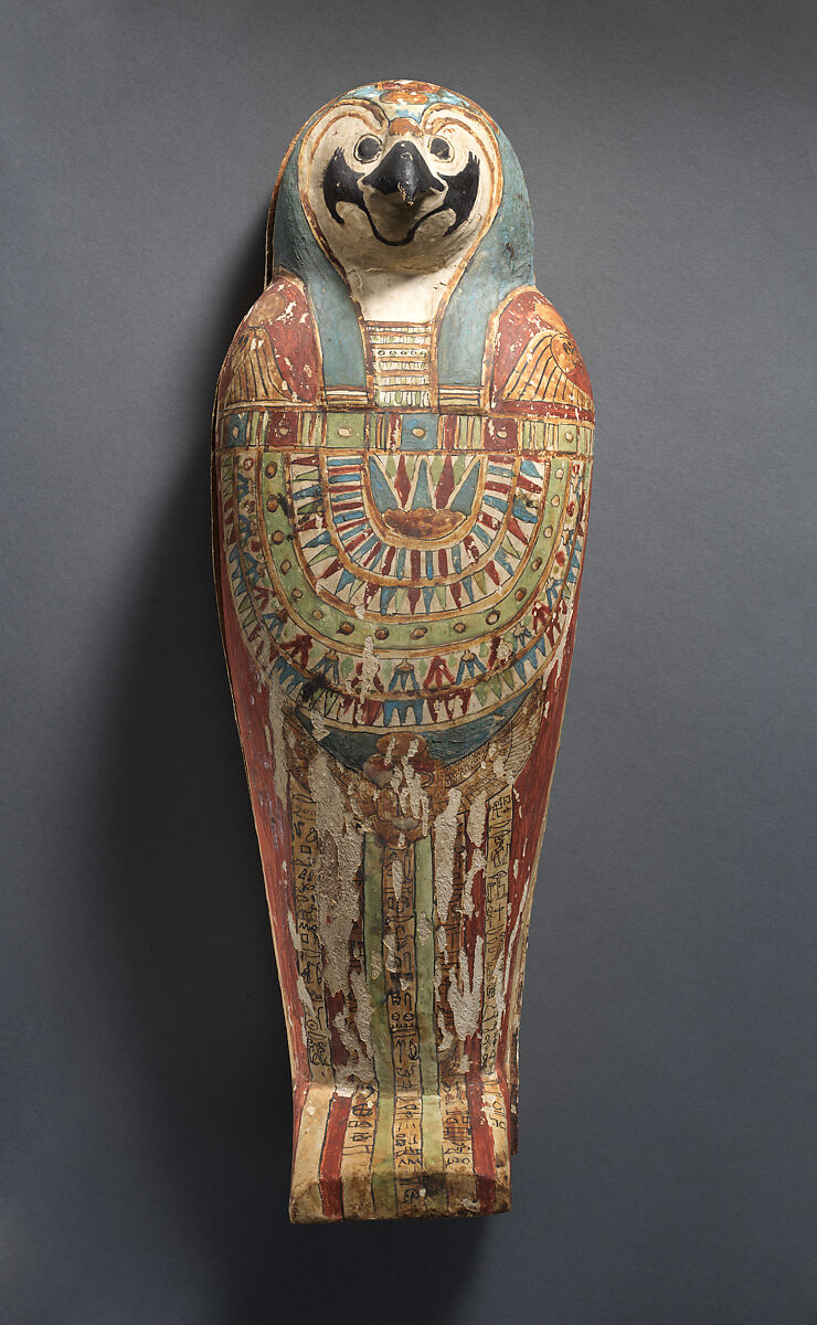 Falcon-form case containing a corn mummy, Painted gessoed wood; mummy: linen, resin, fiber 