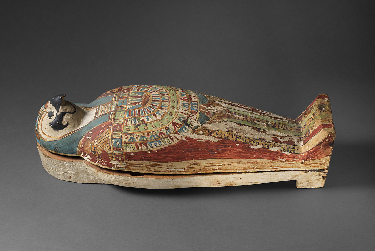 Falcon-form case containing a corn mummy, Painted gessoed wood; mummy: linen, resin, fiber