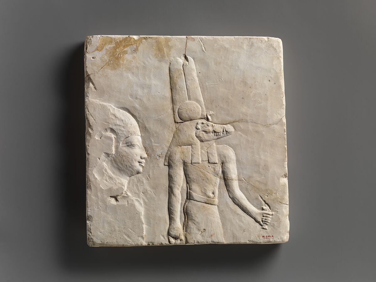 Plaque with head and shoulders of a priestly figure, opposite side head of priestly figure and most of a figure of crocodile-headed god, Limestone, paint