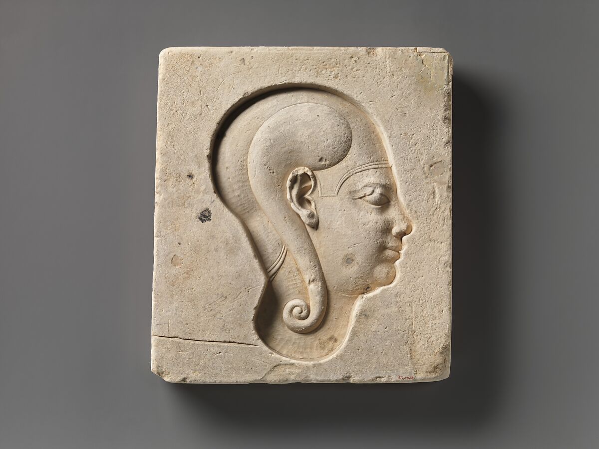 Relief of king's head in blue crown, head of child god on opposite side, Limestone