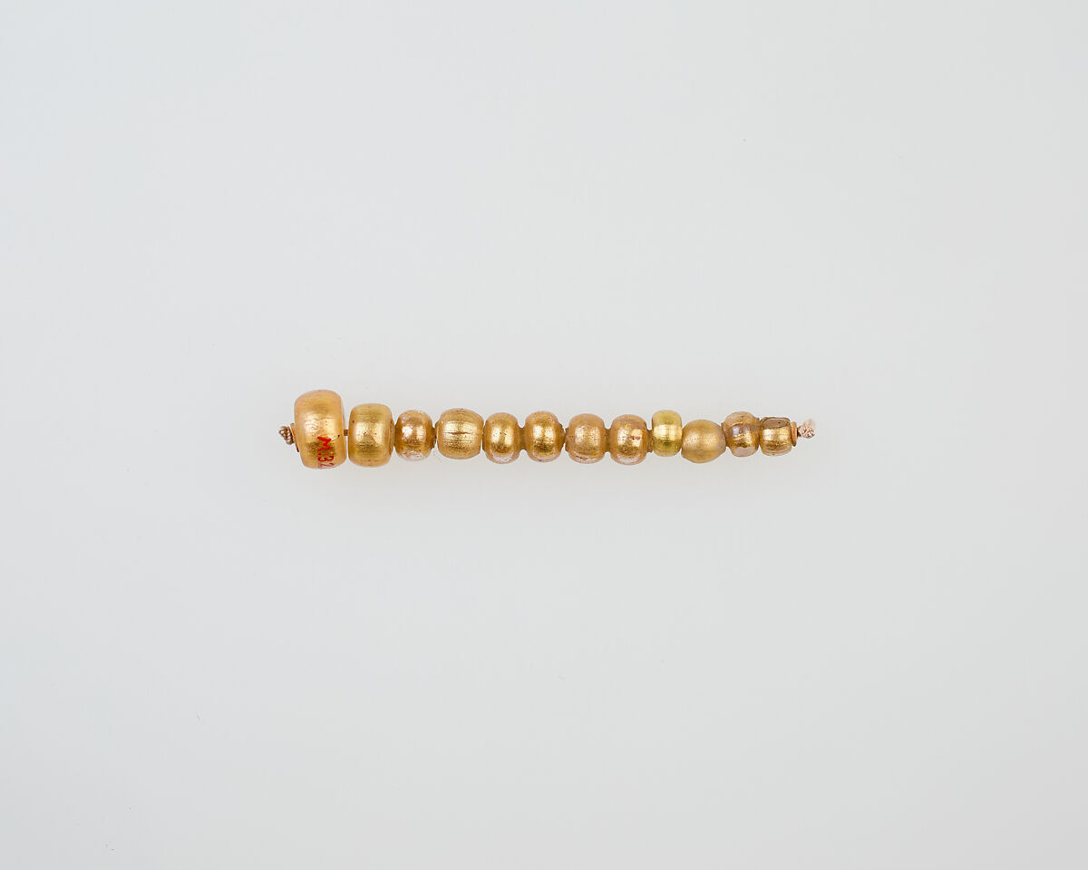 String of 12 elongated disc beads, glass, gold foil 