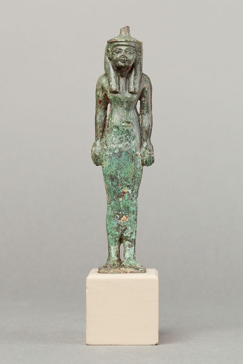 A statue of a woman, thought to be Maat, made of metal.