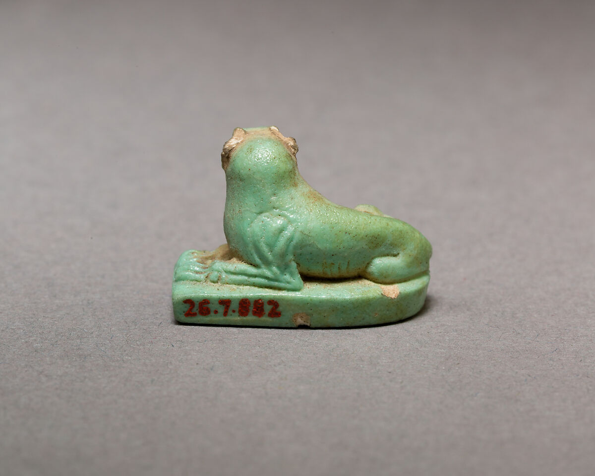 Reclining dog, Pale green faience