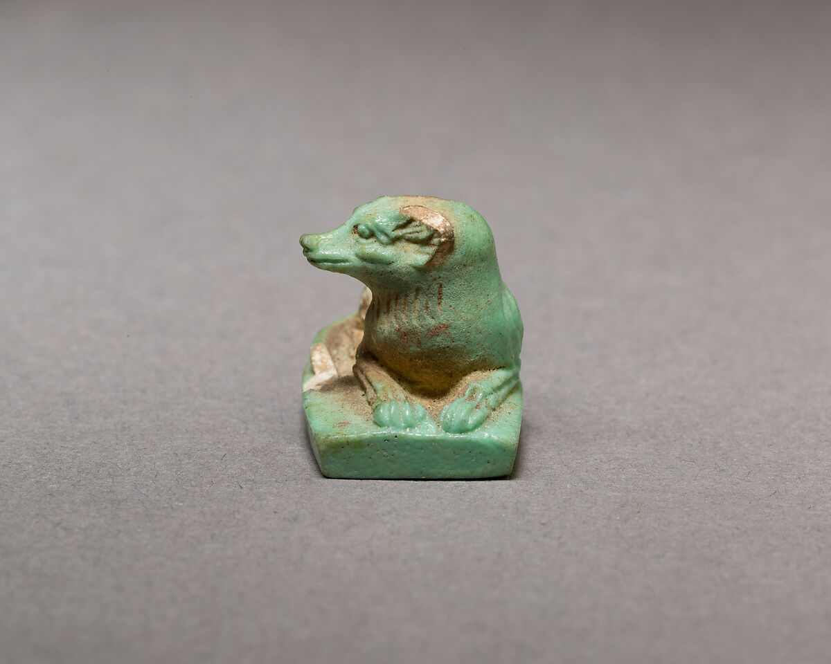 Reclining dog, Pale green faience