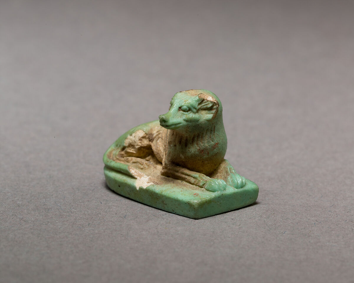 Reclining dog, Pale green faience