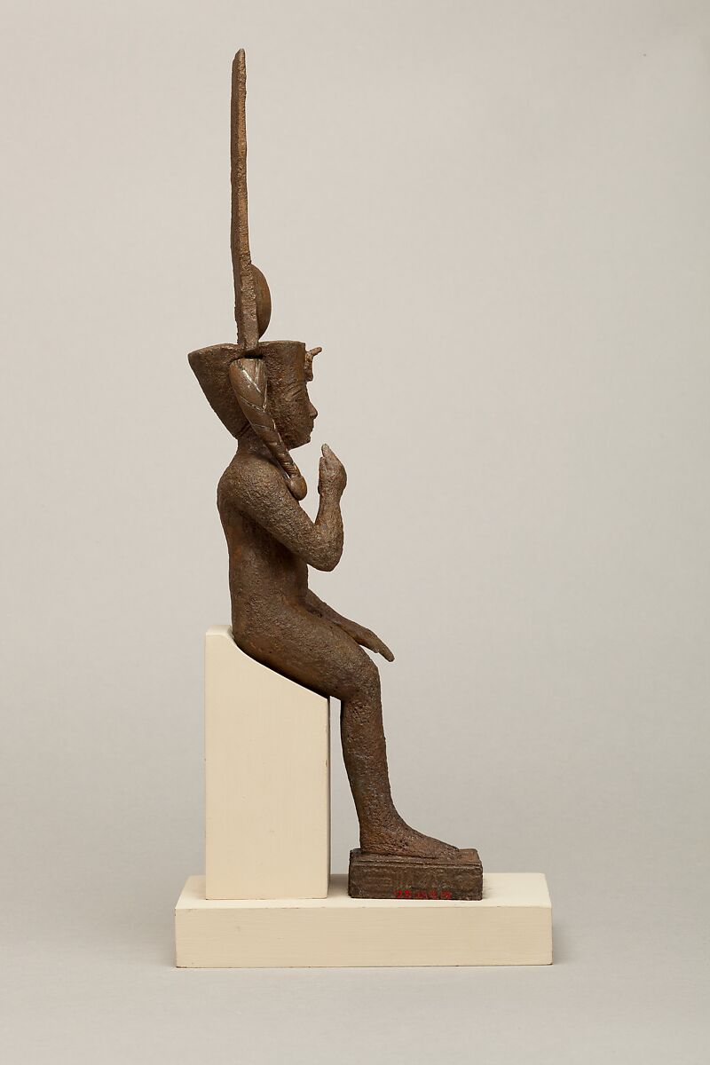 Seated Harpokrates with the crown of Amun, named as "Harpokrates-the-great, the eldest, the first of Amun", Cupreous metal, precious metal inlay