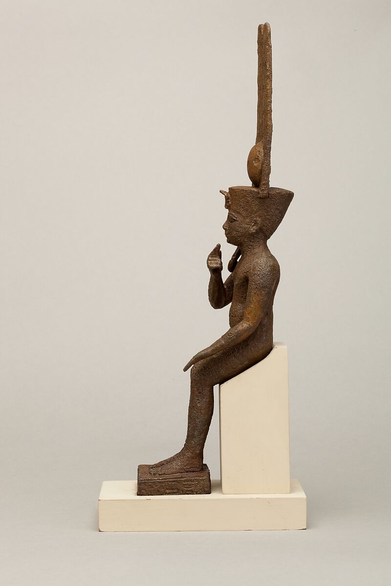 Seated Harpokrates with the crown of Amun, named as "Harpokrates-the-great, the eldest, the first of Amun", Cupreous metal, precious metal inlay