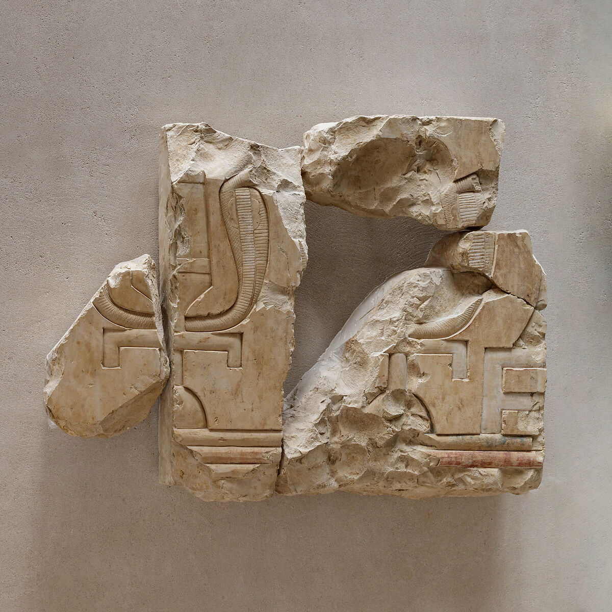 Relief fragments of two sacred emblems, Limestone, paint 