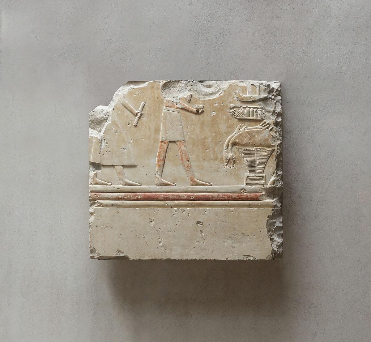 Relief from the tomb of Queen Neferu: a scribe and a cupbearer approach the queen's offering table, Limestone, paint 