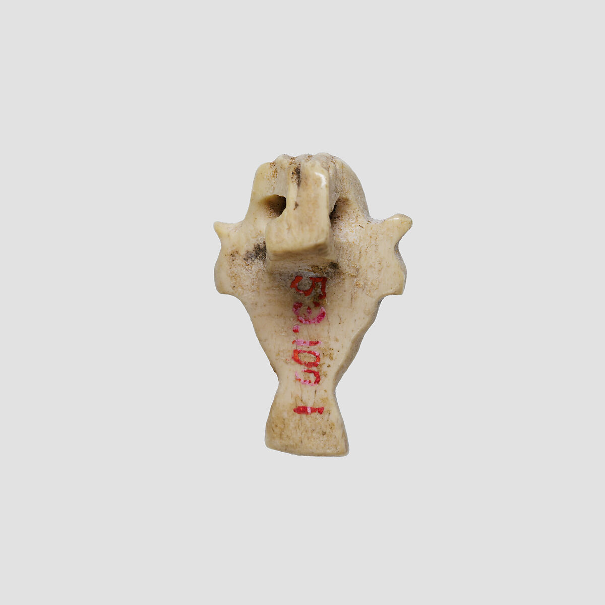 Amulet in the form of a face, Ivory or bone