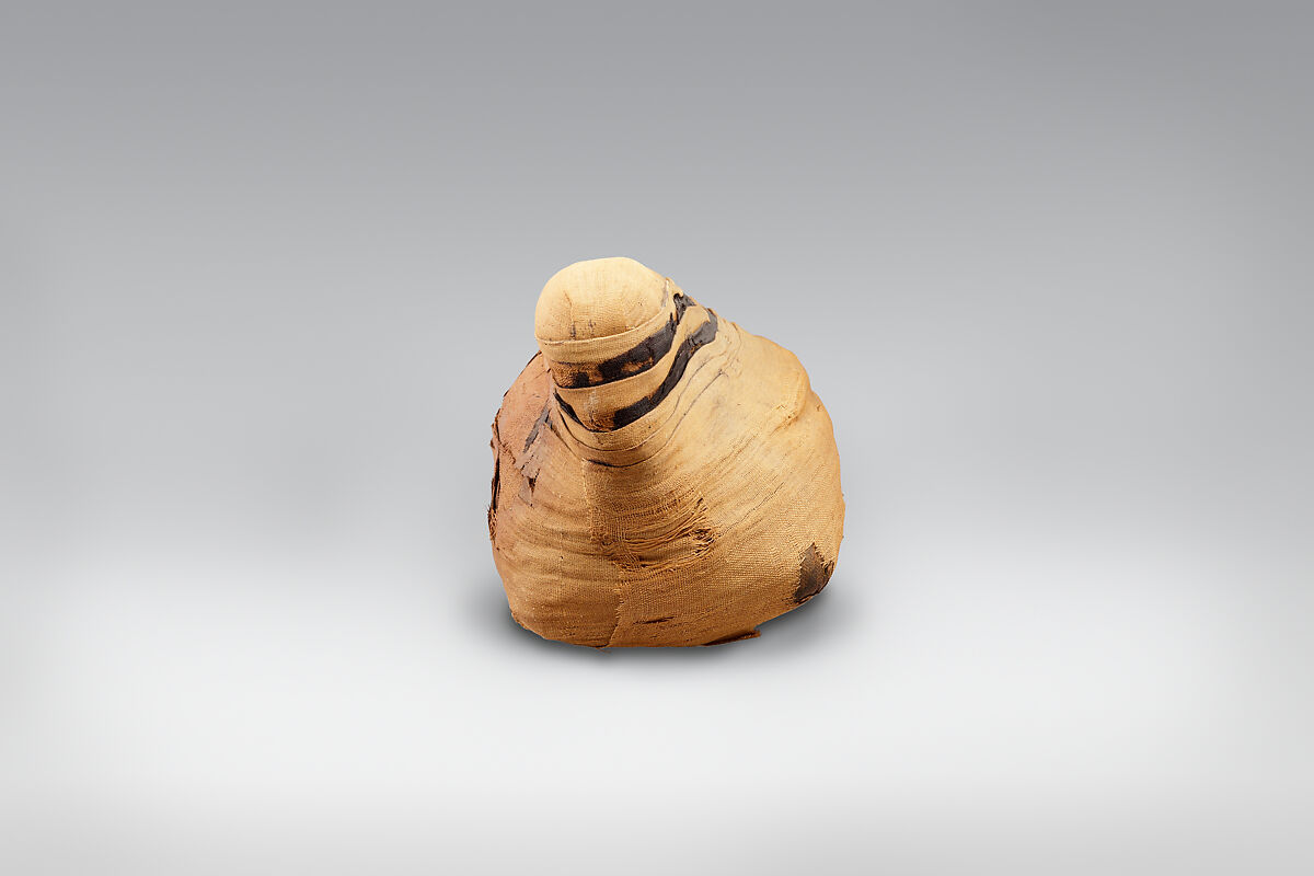 Sacred animal mummy of an ibis, Dyed and unyed linen, animal remains, mummfication materials