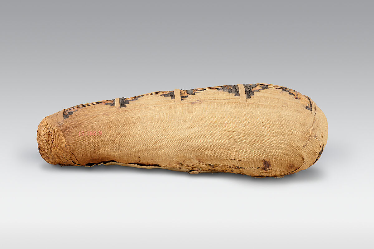 Sacred animal mummy containing small ibises, Dyed and undyed linen, animal remains, mummification materials