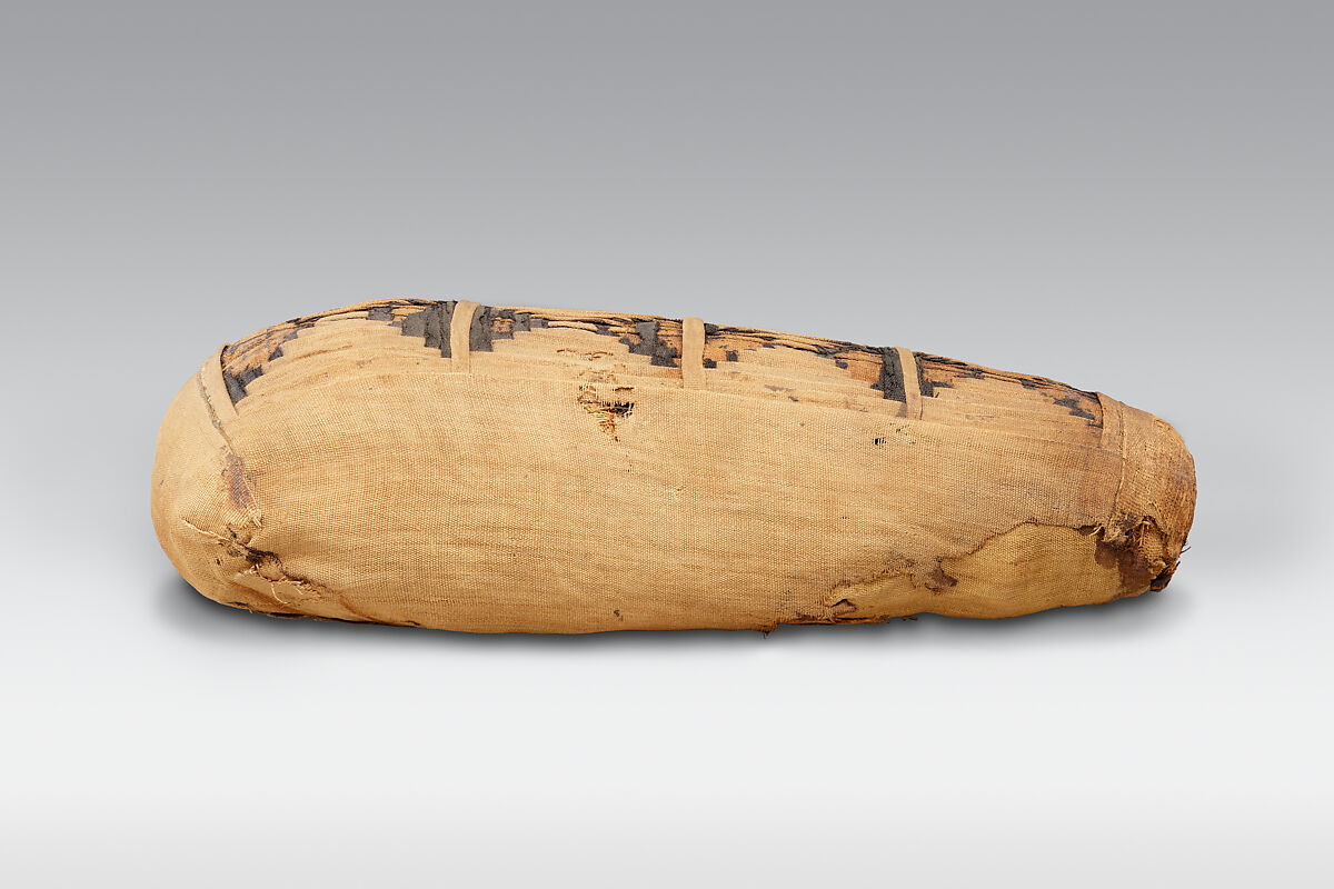 Sacred animal mummy containing small ibises, Dyed and undyed linen, animal remains, mummification materials