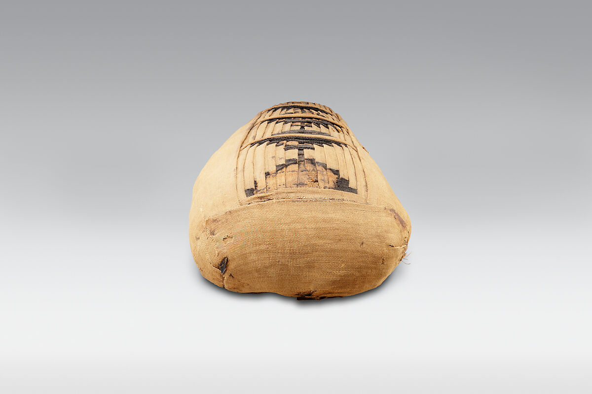 Sacred animal mummy containing small ibises, Dyed and undyed linen, animal remains, mummification materials