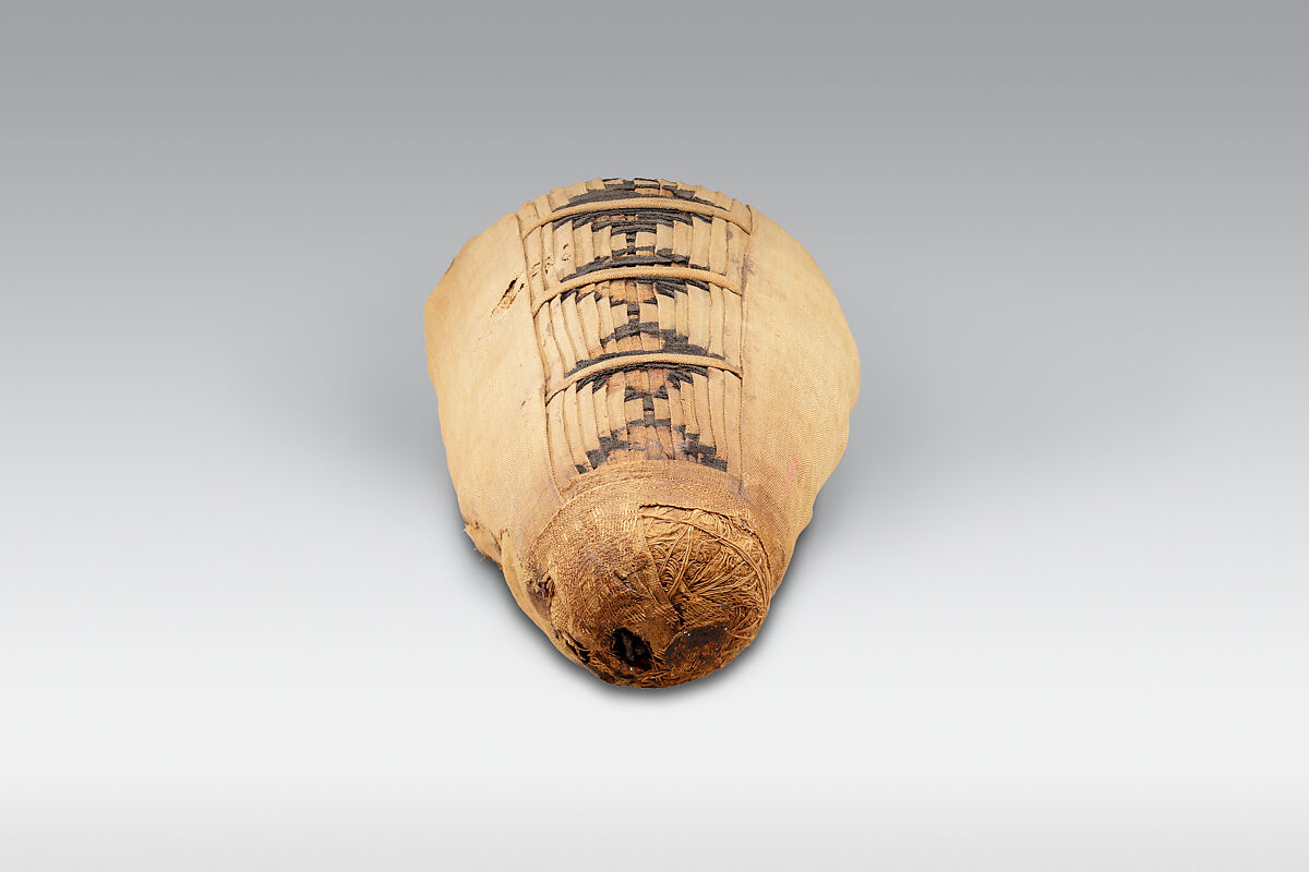 Sacred animal mummy containing small ibises, Dyed and undyed linen, animal remains, mummification materials