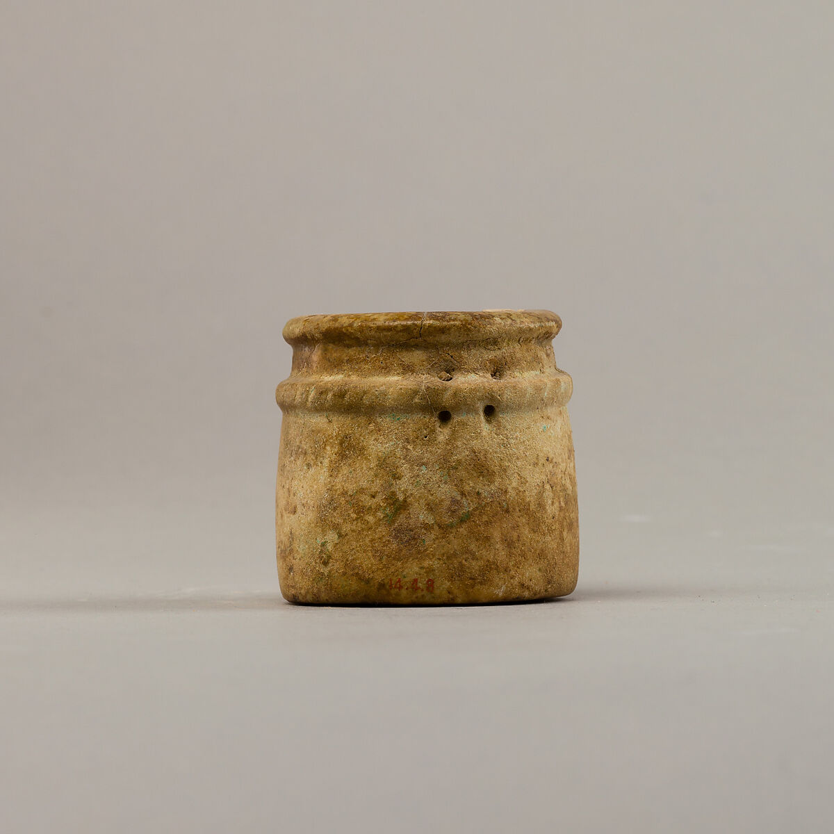 Small cylindrical jar with raised rope band, Faience