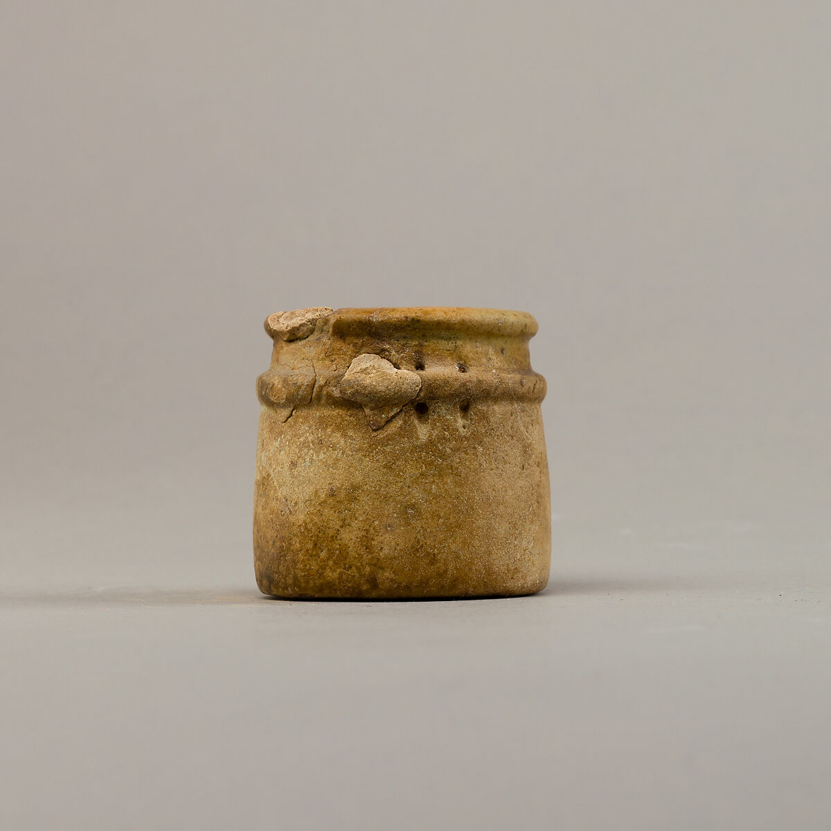 Small cylindrical jar with raised rope band, Faience
