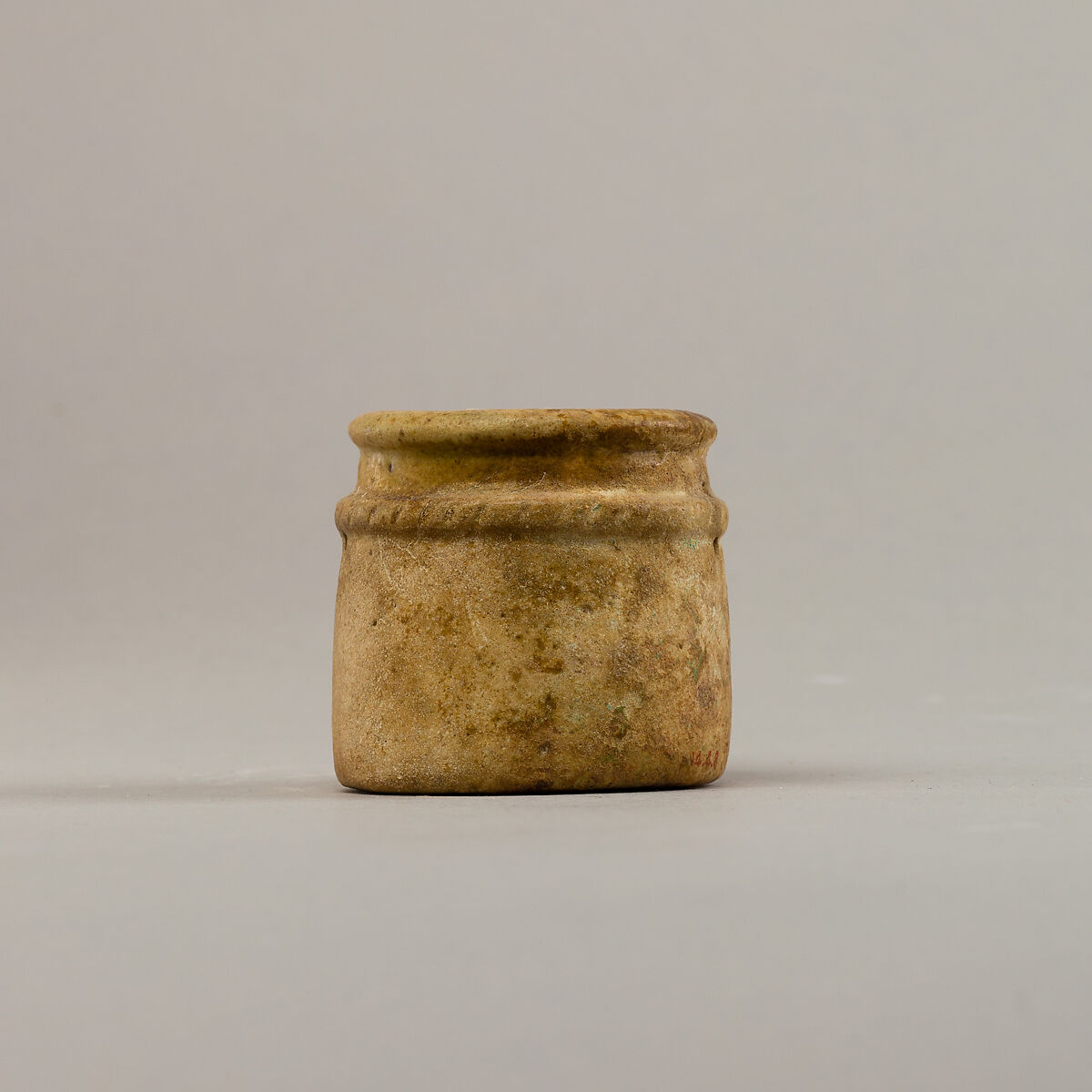 Small cylindrical jar with raised rope band, Faience