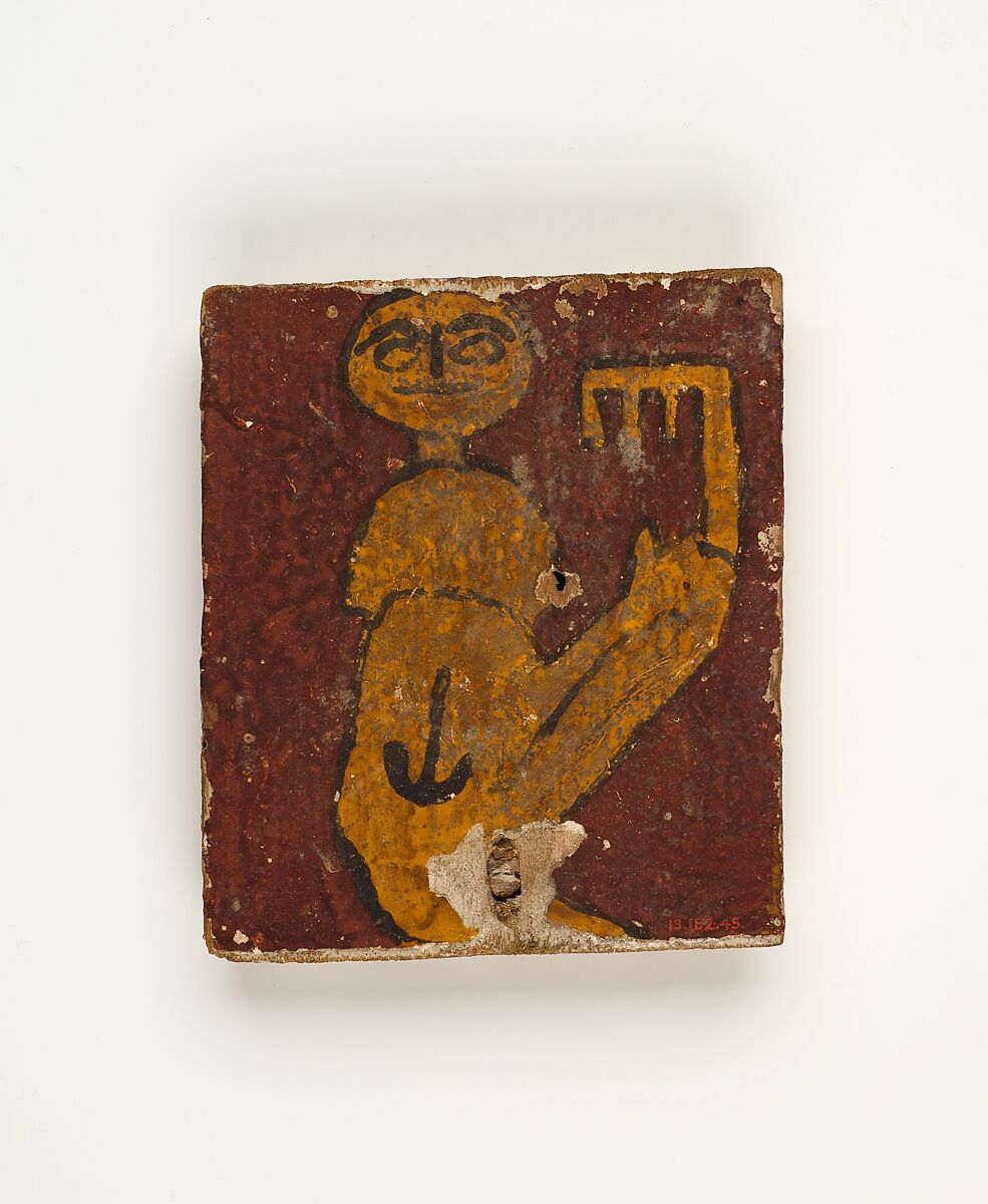 Panel with crouching figure holding a key, Wood, stucco, paint 